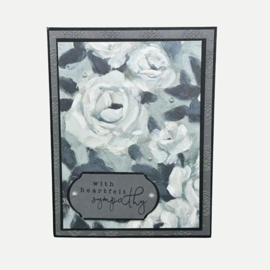 Elegant sympathy card with soft black and white roses, heartfelt message for comfort