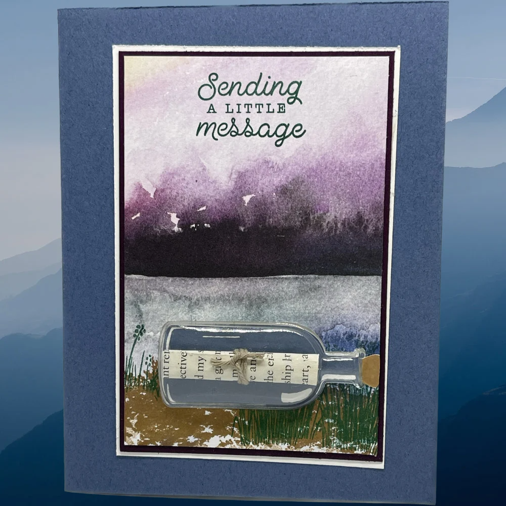 Sending a little message in card that has a 3D message in a bottle. Mountain and lake background