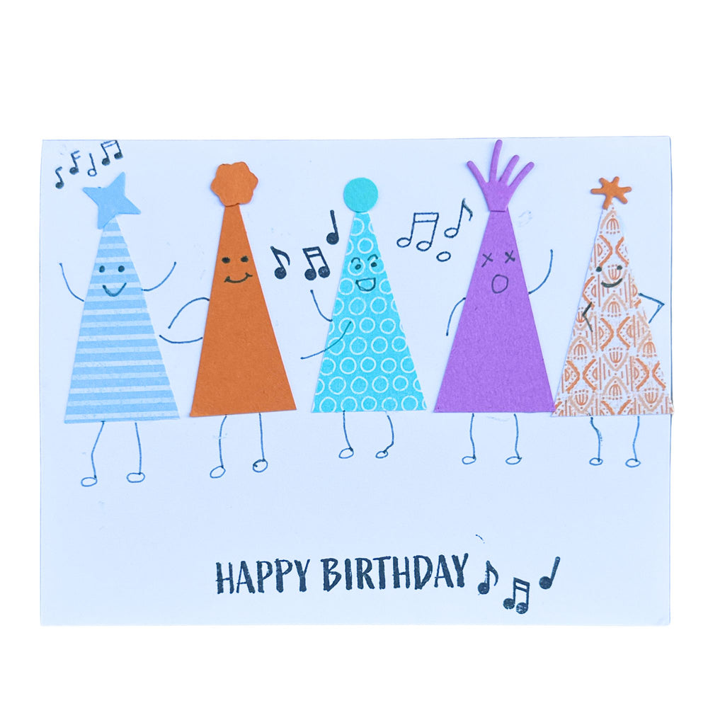 Handmade birthday card featuring colourful party hats singing together with musical notes and a Happy Birthday greeting.