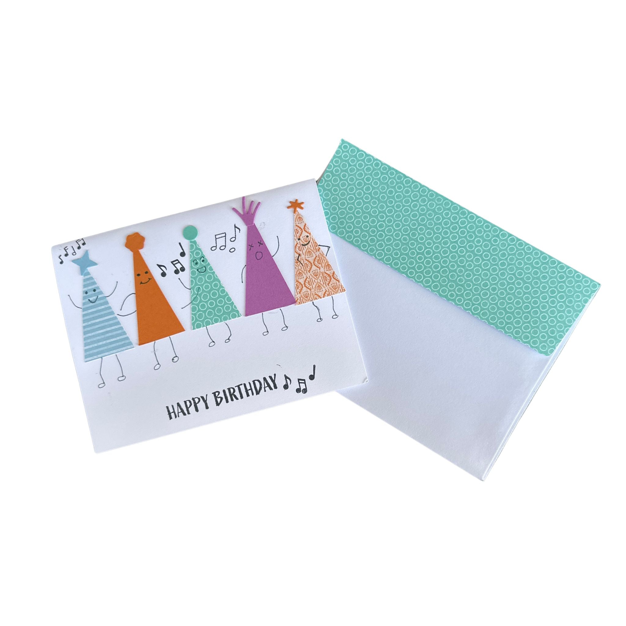 Cute handmade birthday card displayed with its coordinating decorated envelope featuring colourful party hat accents.