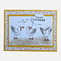 Handmade birthday card featuring three playful seagulls on a beach with a cheerful Happy Birthday greeting.