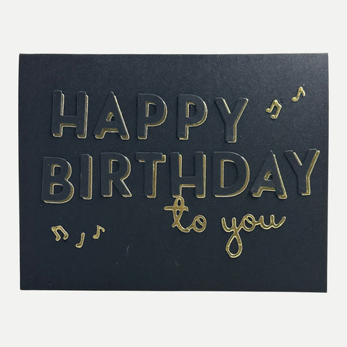 Elegant handmade black birthday card featuring gold foil "Happy Birthday to You" lettering with musical note accents.
