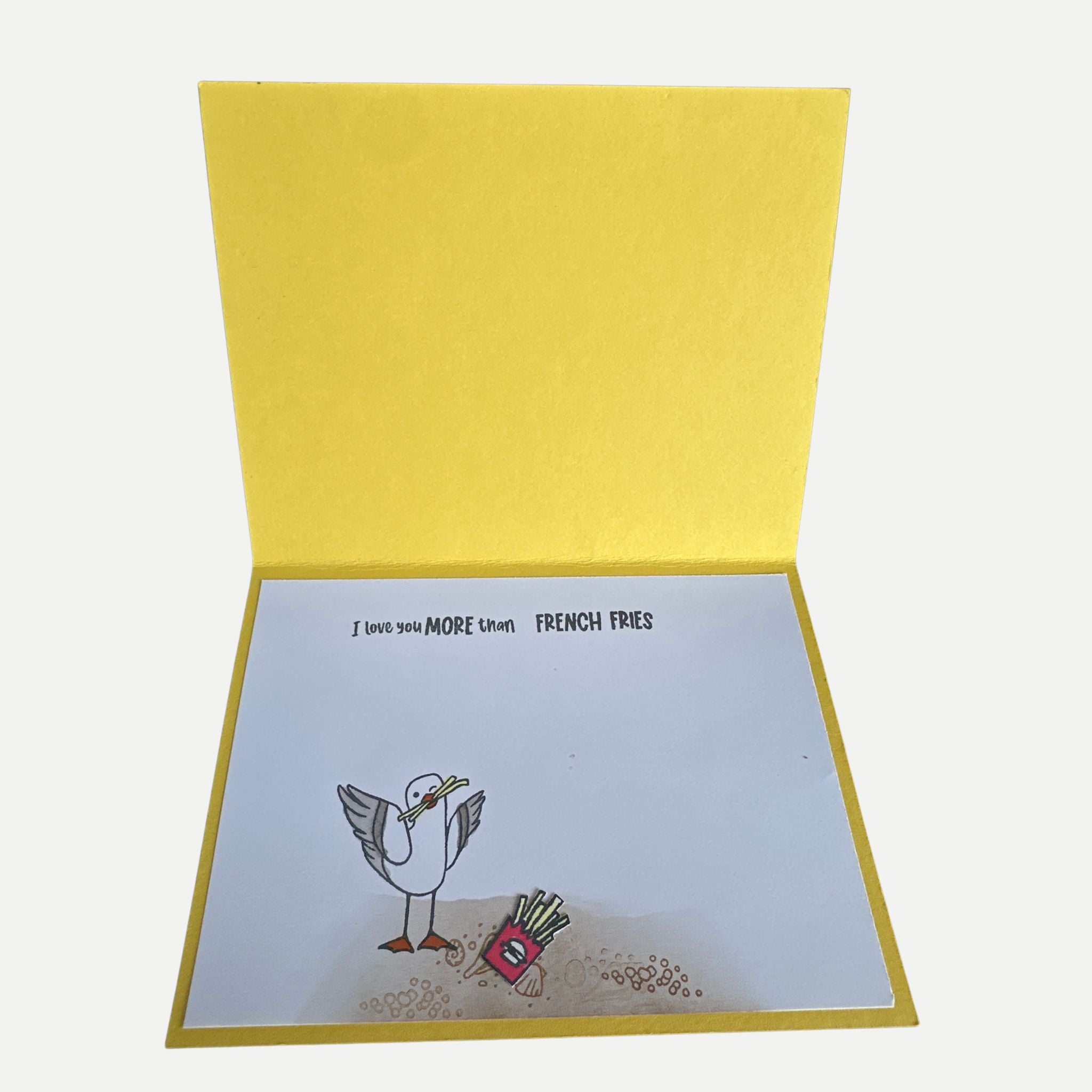 Inside of handmade birthday card featuring the humorous sentiment "I Love You More Than French Fries" with decorative seagull artwork.