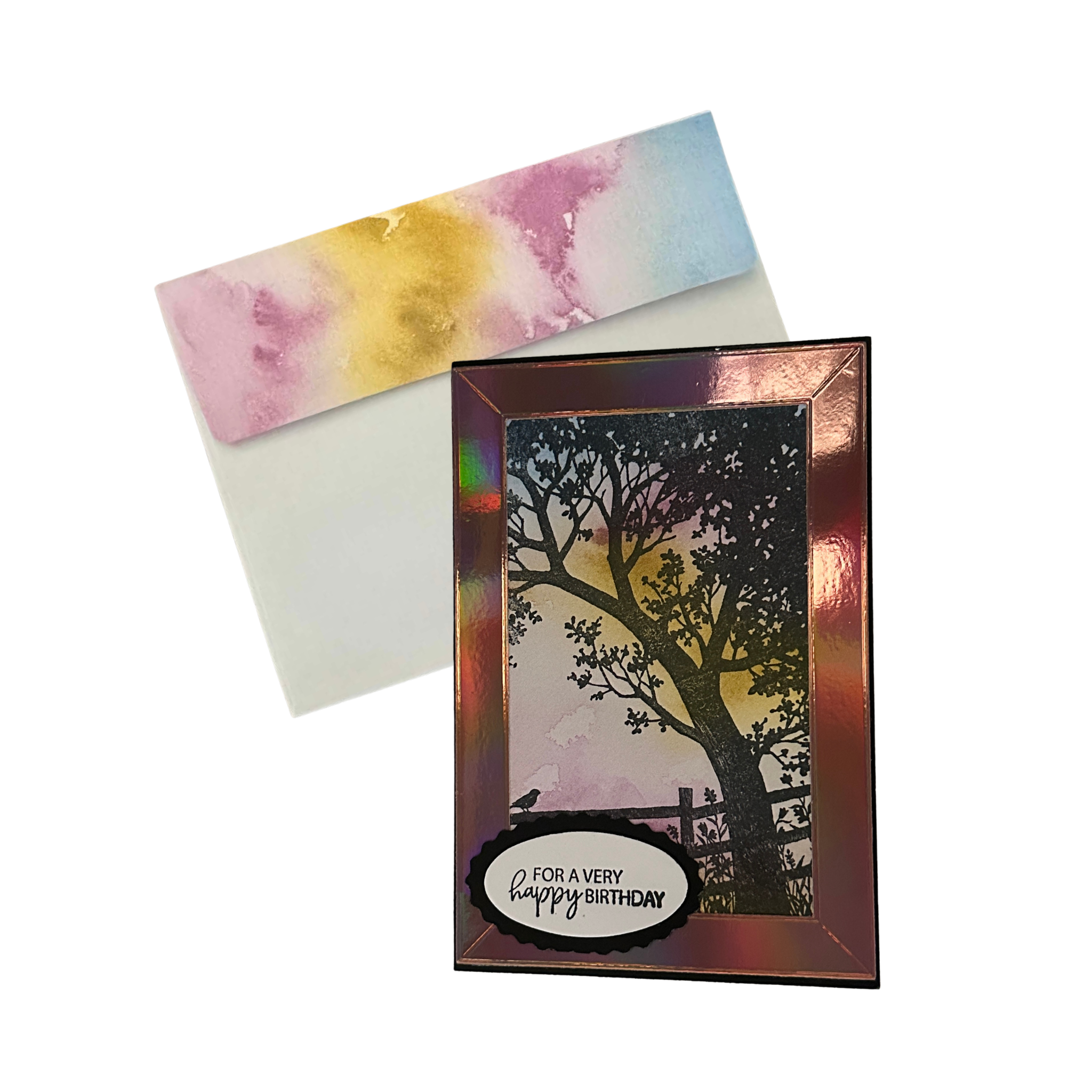 Handmade birthday card displayed with its coordinating hand-decorated envelope featuring a soft pink, yellow, and blue watercolor flap.