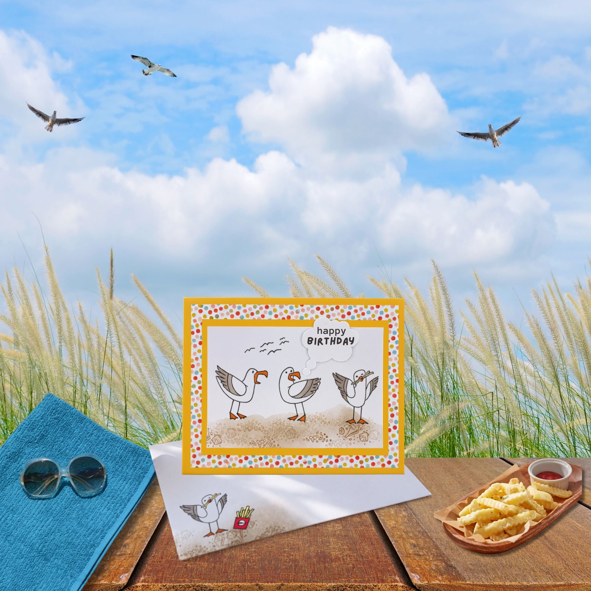 Seagull birthday card on a picnic table at the beach with plate of french fries