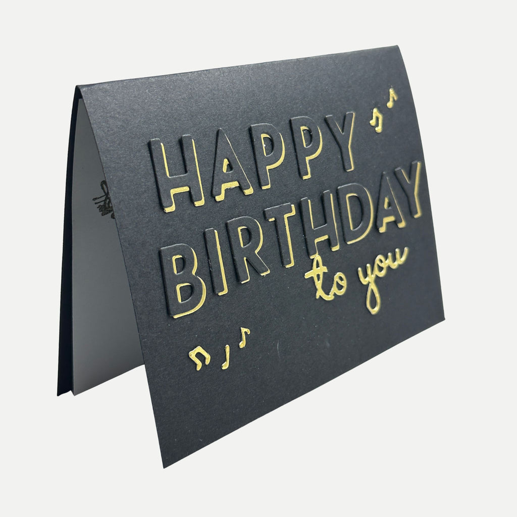 Side view of elegant handmade black and gold birthday card showing its dimensional layered design.