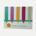 Handmade birthday card featuring colorful zipper embellishments with the greeting "Zipping by to Say Hello."